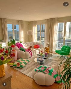 a living room filled with lots of furniture and flowers in vases on the floor