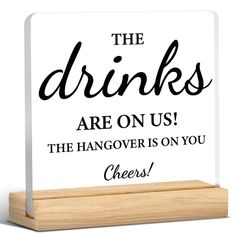 a sign that says the drinks are on us and the hangover is on you cheers