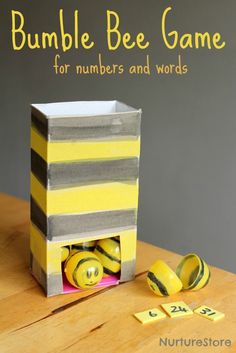 a paper bag that has some yellow and gray items in it with the words bumble bee game for numbers and words