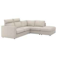 a white sectional couch sitting on top of a white floor