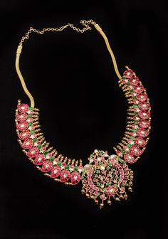 Indulge in the opulence of our Mango Stone studded Necklace, featuring vibrant mango-shaped units in shades of pink, green, and white. Adorned with delicate golden tone beads that sway gracefully, this piece exudes sophistication and exclusivity. Experience the fusion of art, literature, and fashion with our luxurious necklace. Note: This jewelry has no precious metals or stones. Note: Some pics are close up shots to show detail and may make the product appear larger. For a more accurate perspec Luxury Beaded Temple Necklace, Luxury Pink Temple Jewelry Necklaces, Luxurious Necklace, Mango Necklace, Temple Jewelry Necklace, Art Literature, Temple Jewelry, Studded Necklace, Stone Studs