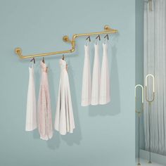 three towels hanging on a rail in front of a shower