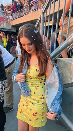 a girl in a yellow dress and jean jacket