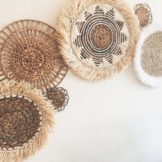 three woven baskets are arranged on the wall