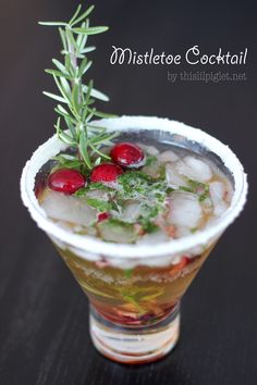 a drink with ice, cranberries and rosemary garnish