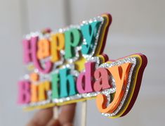 a happy birthday cake topper on a stick