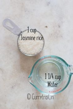 a measuring cup filled with white rice next to a measuring cup containing 1 / 4 cup water