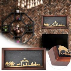 three wooden frames with nativity scenes on them and an ornament in the middle