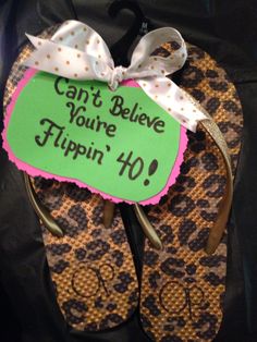 a pair of flip flops with a sign saying can't believe you've flippin'40