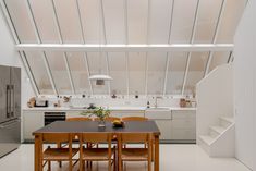 an open kitchen and dining room with white walls