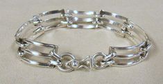 "Sterling silver link bracelet from Mexico. 8 3/8\" long x 9/16\" wide. Stamped Mexico 925. Hook and eye clasp with a fold over safety. Good condition. LB-3" Modern Sterling Silver Bracelet With Box Clasp, Formal Sterling Silver Bracelet With Clasp, Silver Link Bracelet With Box Clasp, Formal Sterling Silver Bracelet With Hook And Links, Sterling Silver Formal Bracelet With Hook And Links, Hallmarked Sterling Silver Link Bracelet, Classic Sterling Silver Bracelet With Hook And Links, Silver Bracelets With Hook And Links For Formal Occasions, Sterling Silver Link Bracelet For Formal Occasions