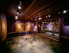 an empty recording room with lights on the ceiling