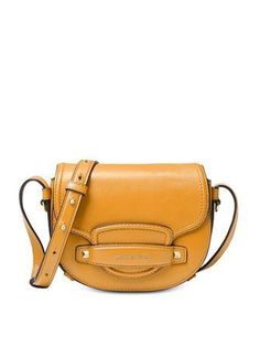 An equestrian-inspired design with all the right details. The Saddle Mini Crossbody features a take-anywhere silhouette with beautiful gold-tone studs and hardware.Mini sized bag; 7"W x 5"H x 2"D (width is measured across the bottom of handbag)21"L to 25"L strapMagnetic flap closureGold-tone exterior hardware & 1 back slip pocket1 interior zip pocket, 2 slip pockets & 3 credit card pocketsLeather; lining: suedeColor: Merigold Shoulder Bags Pattern, Brown Crossbody Bag, Michael Kors Crossbody Bag, Leather Saddle Bags, Brown Crossbody, Brown Shoulder Bag, Michael Kors Collection, Purse Styles, Black Crossbody