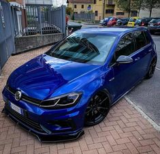 a blue car parked on the side of a road