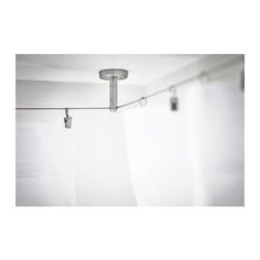 a white shower curtain with two lights hanging from it's side