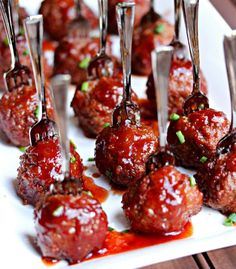 small meatballs with sauce and toothpicks on a white plate, ready to be eaten