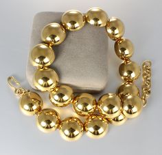 Dramatic, bold look in this 1980s gold tone necklace. It is a Monet piece and marked as such on the hook clasp. Design is modernist with 7/8 inch domed links that look like metal beads. Gold plate is highly polished. necklace is 18 inches long including the extender. Statement making piece in very good vintage condition! 80s Gold Jewelry, Collage Project, 1940s Jewelry, 1980s Jewelry, Spartanburg Sc, Metal Bead, Ball Necklace, Gold Tone Necklace, Hook Clasp