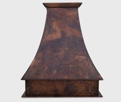 an old - fashioned copper range hood is shown