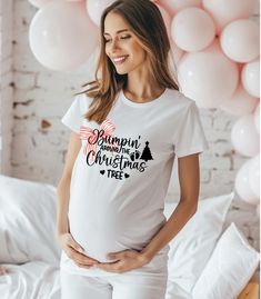 Celebrate the joy of the holiday season with our adorable Christmas Pregnancy Announcement Shirt! This festive maternity shirt features a stylish design perfect for sharing your exciting news during the holidays. Whether you're "bumpin' around the Christmas tree" or looking for the ideal pregnancy gift, this shirt is a must-have for any expecting mom. Made with soft, comfortable material and available in various colors and sizes, it's the perfect way to showcase your holiday spirit and growing bump. Great for holiday parties, family photos, and sharing your little Christmas miracle with loved ones. Material: Soft and breathable fabric Sizes: Available in a wide range of sizes to accommodate all stages of pregnancy Colors: Variety of festive colors Design: Features a cute Christmas-themed g Christmas Pregnancy Announcement Shirt, Christmas Maternity Shirt, Christmas Maternity, Christmas Miracle, Christmas Pregnancy Announcement, Christmas Pregnancy, Pregnancy Announcement Shirt, Maternity Shirt, Pregnancy Stages