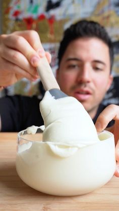 a man is mixing something in a bowl