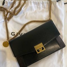 Practical Yet Elegant, This Strap Wallet By Givenchy Has Subtle Finishes With The Brand's Logo On The Flap. This Must-Have Compartmentalized Piece Will Quickly Become A Day-To-Day Companion. Description : Gv3 Chain Wallet. Material : 100% Goat Leather Color : Black, Grey Item Measurements : Height 19 Cm / 7.5 ", Width 12 Cm / 4.7 ", Depth 7 Cm / 2.8 ". Country Of Manufacture : Italy Givenchy Chain Bag, Leather Wallet On Chain With Gold-tone Hardware For Parties, Designer Evening Wallet On Chain, Chic Evening Wallet On Chain With Branded Hardware, Elegant Evening Wallet On Chain With Branded Hardware, Givenchy Gv3, Givenchy Bags, Givenchy Bag, Clutch Black