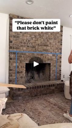 a man standing in front of a brick fireplace with a sign above it that says please don't paint that brick white