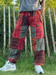 Elevate your festival wardrobe and everyday look with these stunning unisex Hippie Trousers, crafted for ultimate comfort and bohemian flair. Made from sustainable, eco-friendly cotton, these trousers are perfect for anyone who values both fashion and the environment. Whether you're dancing at a festival, flowing through yoga, or embracing your free-spirited lifestyle, these trousers are designed to keep you feeling and looking amazing! Why You'll Love These Trousers? - Unique Striped Stonewashe Bohemian Summer Festival Bottoms, Bohemian Harem Pants With Pockets For Vacation, Bohemian Style Relaxed Fit Bottoms, Bohemian Beach Cotton Pants, Hippie Style Relaxed Fit Bottoms For Festival, Bohemian Summer Harem Pants With Pockets, Bohemian Harem Pants With Pockets For Summer, Summer Bohemian Baggy Pants, Red Hippie Style Pants For Festival