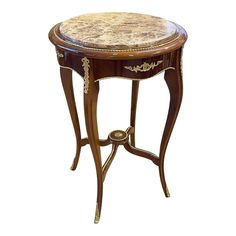 an ornate wooden table with marble top