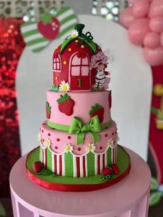 a three tiered cake decorated with strawberrys and farm animals on top of it