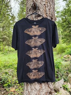 ❧Hand carved eye moths printed with bleach on a black T-shirt ❧ This is a MADE TO ORDER listing and will take 1-8 weeks to ship out. ❧Please note that due to the nature of the printing process, there may be slight variations to the print itself. ❧ SIZE CHART (Unisex/men's sizing,measured flat across chest and from shoulder to bottom hem): S- 17" Chest, 24" Long M- 19" Chest, 28" Long L- 21" Chest, 28" Long XL- 23.5" Chest, 30" Long 2XL- 25" Chest, 30" Long ❧Fabric is cotton and provides some stretch. ❧If you see a design you like but I do not have the size/style of garment you want in stock please message me! I am happy to make custom items when possible. Bleach Tshirt Designs, Bleach T Shirt, Moth Print, Reverse Tie Dye, Sensory Friendly, Bleach T Shirts, 8 Weeks, Black T Shirt, Custom Items