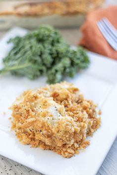 a white plate topped with chicken and broccoli covered in gravy next to a casserole dish