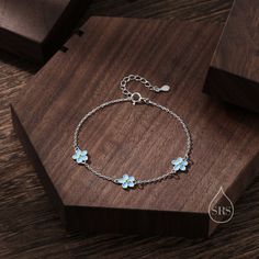 Enamel Forget Me Not Flower Motif Bracelet in Sterling Silver, Daisy Bracelet, Daisy Flower Bracelet, Forget-me-not Flower Bracelet Bracelet Chain length: 16cm plus 3cm extension chain (19cm in total).   Production method:  Small Batch Lost-wax casting. Stamp: 925 SRS - our branded stamp. All parts are made in-house.  Materials and Care: These are made with solid sterling silver and coated with precious metal Rhodium or 18ct yellow gold. When not wearing, please keep in a sealed plastic bag.  Pa Sterling Silver Flower Bracelet, Daisy Flower Bracelet, Blossom Bracelet, Forget Me Not Flower, Daisy Bracelet, Lost Wax Casting, Flower Motif, Sterling Silver Flowers, Flower Bracelet