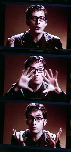 the man in glasses is making gestures with his hands while standing on a television screen