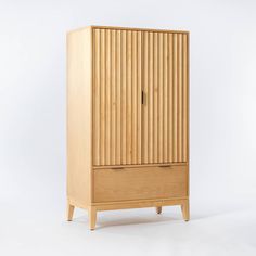 a tall wooden cabinet sitting on top of a white floor