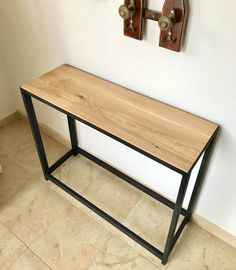 a wooden table sitting in the corner of a room