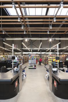 the inside of a grocery store with people shopping