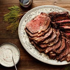 sliced steak on a plate next to other dishes and utensils