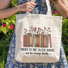 there is no such thing as too many books tote bag in front of flowers