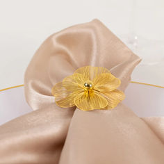 a napkin with a gold flower on it