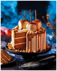 a cake with caramel toppings and apples is on a plate next to other dessert items