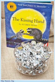 the kissing hand by audrey penn book and silver foil candies in front of it