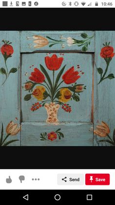 an old wooden frame with flowers painted on it