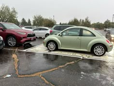 a green car is parked in a parking lot