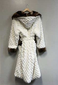 Indulge in the pinnacle of sophistication with our Thick Faux Fur Winter Long Sleeve robe. This masterpiece of fashion effortlessly combines opulence and style, ensuring you radiate timeless elegance in every setting. Whether you're navigating daily life, attending work commitments, cherishing family gatherings, embracing casual outings, savoring dinner dates, embarking on vacations, reveling in cocktail parties, or even gracing weddings, this robe adapts seamlessly. Its versatility transcends o White Hooded Fur Coat For Winter, White Hooded Fur Coat With Faux Fur Lining, White Hooded Fur Coat For Fall, White Fitted Cozy Outerwear, Cozy Fitted White Outerwear, Cozy White Fur Coat With Faux Fur Lining, Luxury White Outerwear With Faux Fur Lining, Luxury White Fur Coat With Faux Fur Lining, Luxury White Fur Coat For Winter