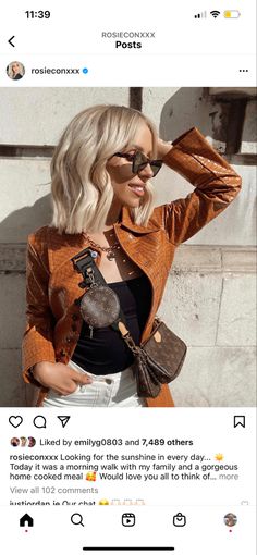 a woman with blonde hair wearing sunglasses and a brown jacket