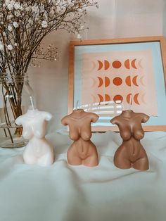 two little bears sitting next to each other in front of a vase filled with flowers