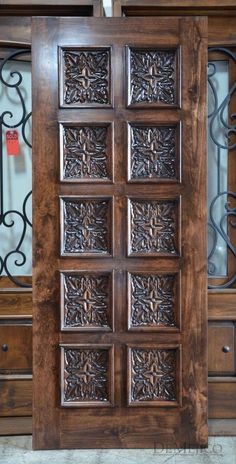 a wooden door with intricate carvings on it