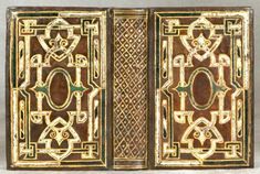 an old book with gold trimming and decorative designs on the front, inside and outside