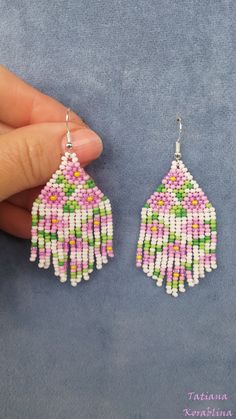 These handmade unique earrings with abstract floral print are made of high-quality Czech beads and strong synthetic thread. I use my author's scheme . These earrings are elegant, fashionable, and highly versatile, suitable for everyday wear. Color: white,pink, green, yellow . 100% hand made with love! Measurements: Length-about 7cm (with schwenze) , Width -3 cm Materials: Silver plated ear hooks Czech glass beads Nylon Thread White Flower-shaped Jewelry With Dangling Beads, Summer White Flower Earrings With Colorful Beads, White Dangle Flower Earrings With Colorful Beads, White Dangle Flower Earrings With Beads, White Flower Dangle Earrings With Colorful Beads, White Flower Earrings With Dangling Round Beads, White Flower Earrings For Crafting, Traditional White Flower Earrings, Handmade White Beaded Drop Earrings