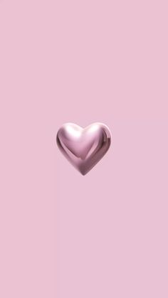 a pink heart shaped object floating in the air